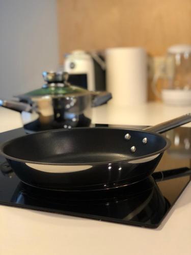 a black frying pan sitting on top of a stove at Ring Stop Holiday Apartment 11 in Sigulda