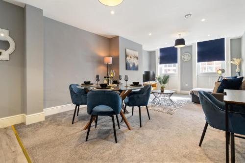 a living room with a table and chairs and a couch at WhiskAwayStays - Victoria House - Apartment 3 in Worcester