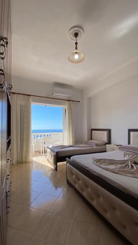 een slaapkamer met 2 bedden en uitzicht op de oceaan bij Sea View Studios and Apartments Vila Tani-2 in Sarandë