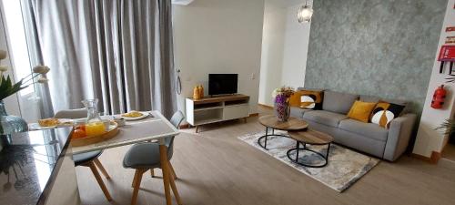 a living room with a couch and a table at Villa City in Funchal