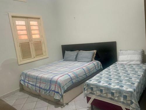 1 Schlafzimmer mit 2 Betten und einem Fenster in der Unterkunft Casa Maria Toda Linda N 53 in Belém