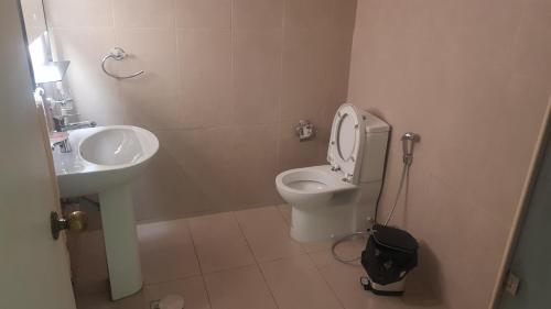 a small bathroom with a sink and a toilet at M apartment in Kuwait