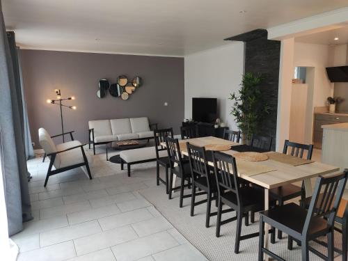 une salle à manger et un salon avec une table et des chaises dans l'établissement Maison avec Jardin - 10 pers - Proche Paris Disney & Golf - Idéal Pro & Familles, à Lésigny