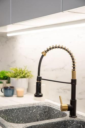 a kitchen sink with a kitchen faucet at Aroeira Turquoise Home in Aroeira
