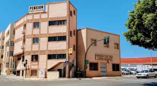 a building on the corner of a street with a traffic light at Pensión Torrecárdenas in Almería