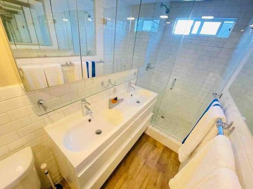 a white bathroom with a sink and a toilet at Modern 1 Bed Famous Venice 10B in Los Angeles