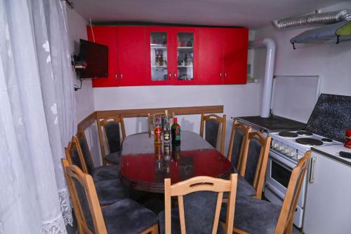 a small kitchen with a table with chairs and a stove at Kuća Cvetković in Pirot