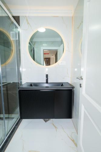 a bathroom with a black sink and a mirror at Ema Apartments in Plav