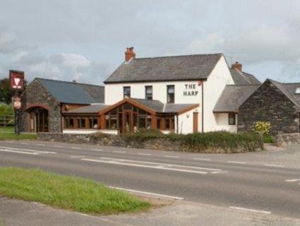 a large white building on the side of a road at The Harp at Letterston in Letterston