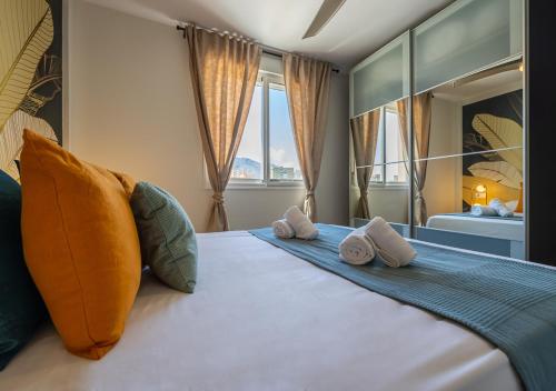 a bedroom with a large bed with pillows on it at Torremolinos Centro terraza wifi parking ascensor a la playa a 5 min in Torremolinos