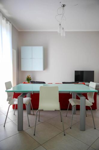 a dining room with two tables and white chairs at CasaA in La Spezia