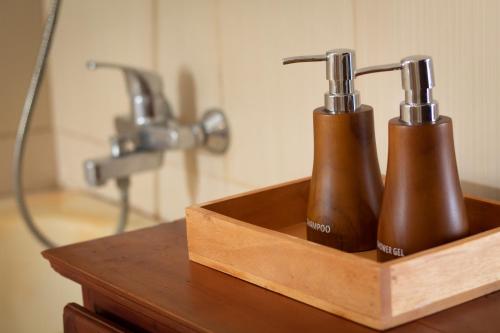 two toothbrushes in a wooden holder on a table at The Kanjeng Signature Sidemen in Sidemen