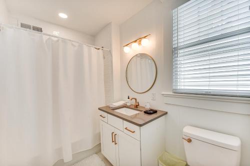 a white bathroom with a sink and a mirror at Elizabeth City Home with Fire Pit Less Than 1 Mi to Downtown in Elizabeth City