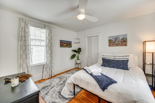 a bedroom with a bed and a desk and windows at Elizabeth City Home with Fire Pit Less Than 1 Mi to Downtown in Elizabeth City