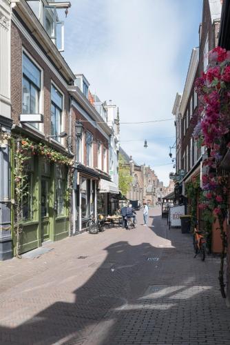 a city street with buildings and people walking down the street at Six Boutique Hotel in Haarlem