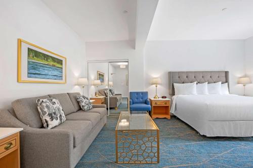 a hotel room with a bed and a couch at Crown Columbia Hotel; BW Premier Collection in Trail