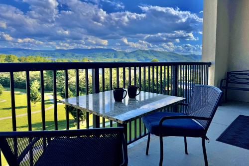 a table and chairs on a balcony with a view at Abundantly Blessed Mountain View 3604 in Pigeon Forge