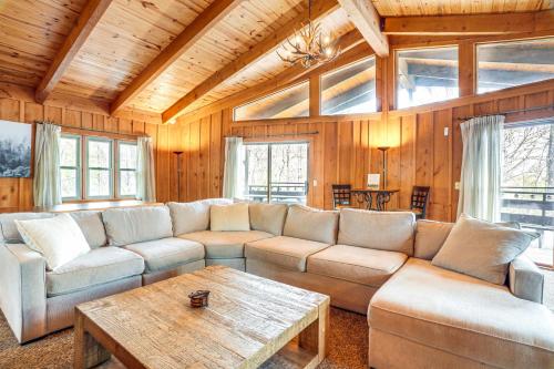 a living room with a couch and a table at Treehouse-Style Cabin, 1 Mi to Massanutten Resort in McGaheysville