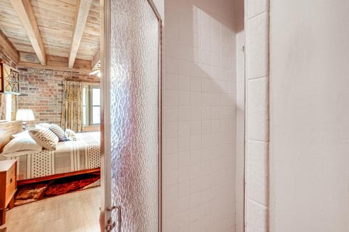 a bathroom with a glass door leading to a bedroom at Treehouse-Style Cabin, 1 Mi to Massanutten Resort in McGaheysville