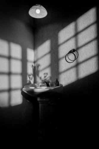 a bathroom with a sink in a dark room at Chácara Nosso Sonho in Atibaia