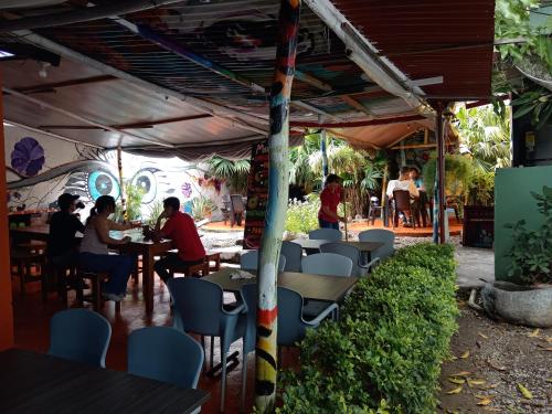 a group of people sitting at tables in a restaurant at Casona Don Juan Hostel in San Gil