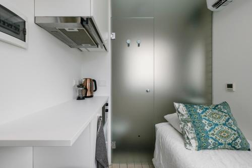 a small bedroom with a bed and a cabinet at Apartment for one - white in Tallinn