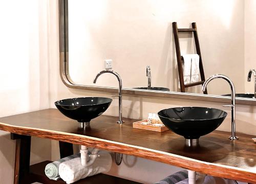 two black sinks on a counter in a bathroom at Gingerbread Suites in Port Elizabeth