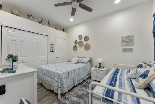 a bedroom with two beds and a ceiling fan at 5600 Seaview Ave, Unit 15 in Wildwood Crest