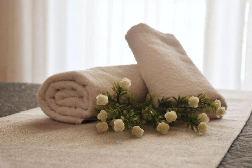 a towel with flowers on it on a table at Luxury Rhodian Panorama in Ixia