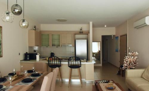 a kitchen and living room with a table and chairs at Luxury Rhodian Panorama in Ixia