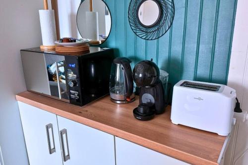 a counter with a microwave and a coffee maker on it at Studio chic & cosy, RER D, Orly 15min in Villeneuve-Saint-Georges