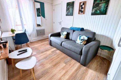 a living room with a couch and a table at Studio chic & cosy, RER D, Orly 15min in Villeneuve-Saint-Georges