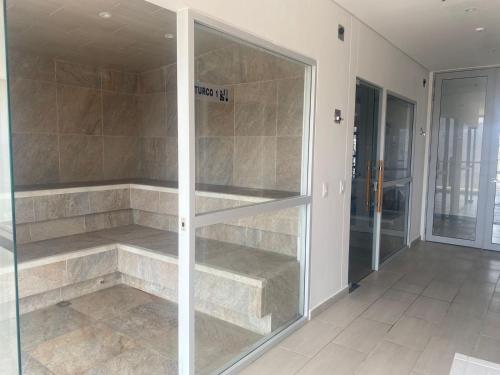 a glass display case in a room with a door at APARTAMENTO EN GAIRA PLAYA SALGUERO SANTA MARTA in Gaira