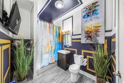 a bathroom with a toilet and some plants at The Penthouse @ Luxro in Chicago