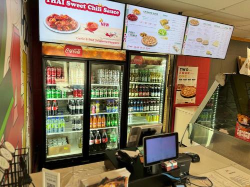 a cashier in a store with a cashierasteryasteryasteryasteryasteryastery at Travel Inn Cochrane in Cochrane