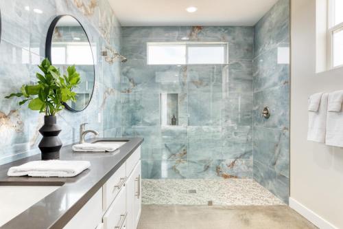 a bathroom with a sink and a shower at Ishan by AvantStay Designer Joshua Tree Oasis in Yucca Valley