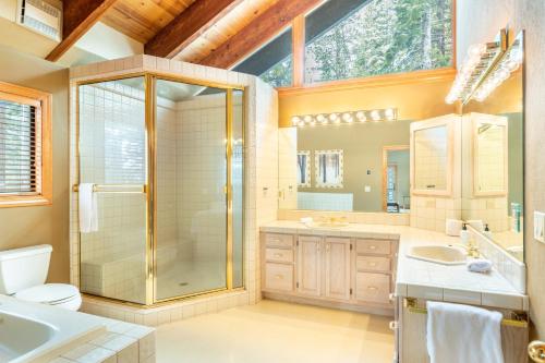 a bathroom with a shower and a toilet and a sink at Frosted Shore by AvantStay Luxury Lake Views in Incline Village