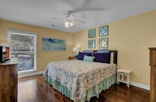 a bedroom with a bed and a ceiling fan at 15 Lake Village by AvantStay Golf Course Lagoon Views in Isle of Palms