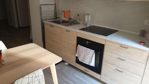 a kitchen with a sink and a stove at Bio house posto auto aria condizionata in Bologna