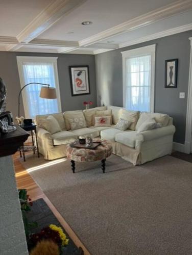 a living room with a couch and a coffee table at Jersey St Lovely in Marblehead
