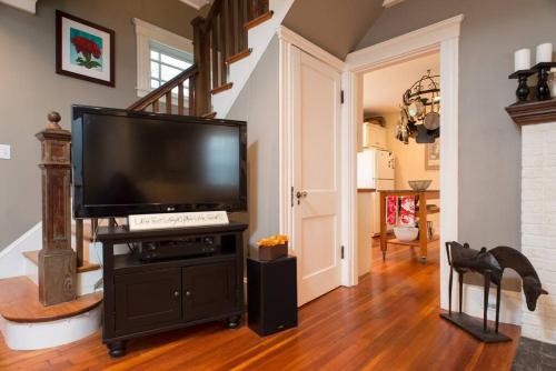 a living room with a large flat screen tv at Jersey St Lovely in Marblehead
