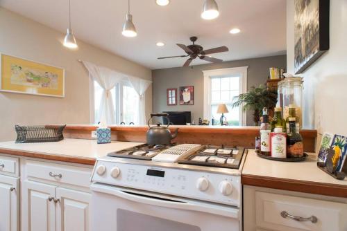 a kitchen with a white stove top oven next to a counter at Jersey St Lovely in Marblehead
