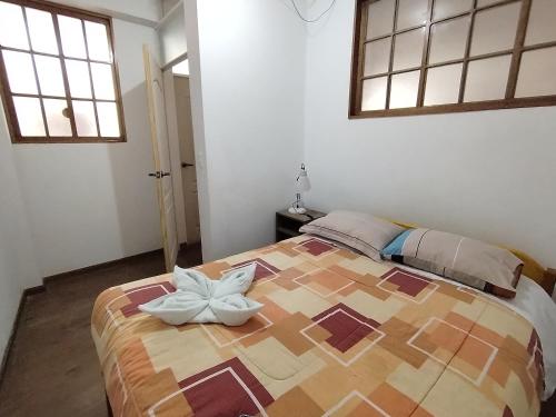 a bedroom with a large bed with a flower on it at PANORAMIC & AMAZING VIEWS Pvt apart close main square in Cusco