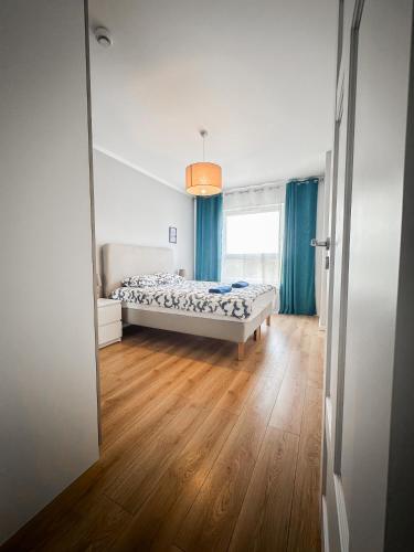 a bedroom with a bed and a large window at 306 BALTICA Hallera 223 Apartamenty zresetuj się w Gdańsku blisko morza in Gdańsk