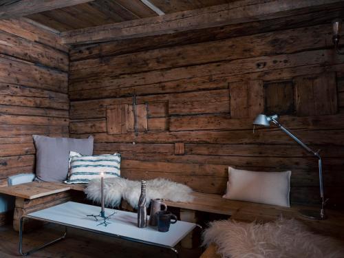 a room with a wooden wall with a bench and a lamp at Green Chalet from Centuries ago in Reith bei Kitzbühel