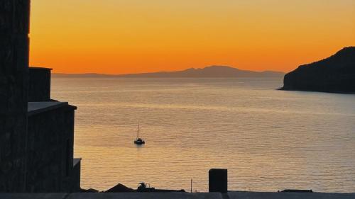 a boat in the water at sunset at Eleonas Limeni in Limeni