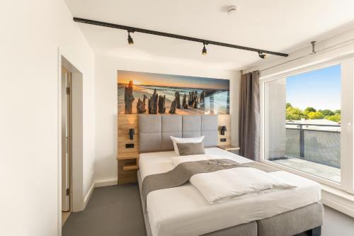 sypialnia z łóżkiem i dużym oknem w obiekcie Quartier’76 w mieście Dahme