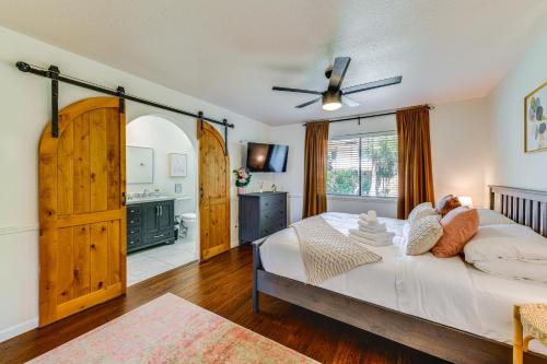 a bedroom with a large white bed and a bathroom at Desert Home with Private Pool in Mesa Near Golf in Mesa