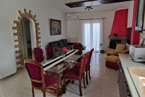 a kitchen and living room with a table and chairs at Panoramic view near airport in Artemida