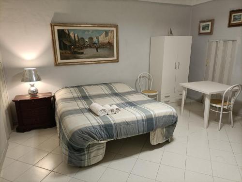 a bedroom with a bed with two stuffed animals on it at La casetta di Mary in Monopoli